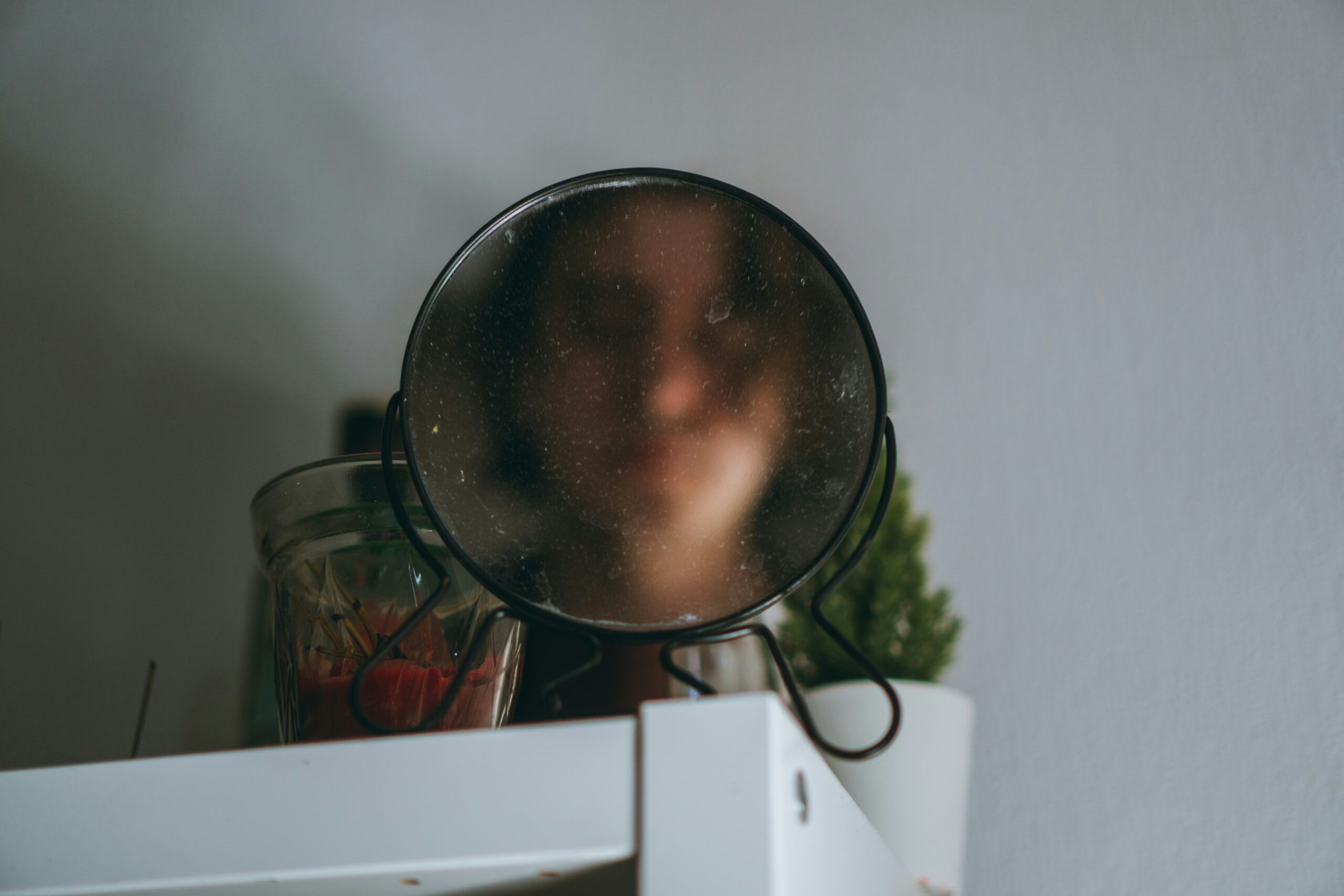 person looking in the mirror with body image struggles